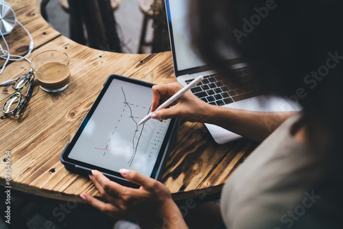 Photography Faceless woman drawing diagram on tablet