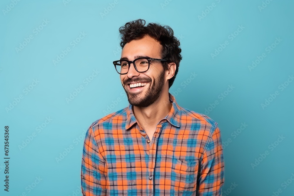 Portrait of a happy young man with eyeglasses on blue background Portrait of a happy young man with eyeglasses on blue background