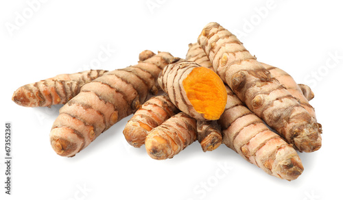 Whole and cut turmeric roots isolated on white photo
