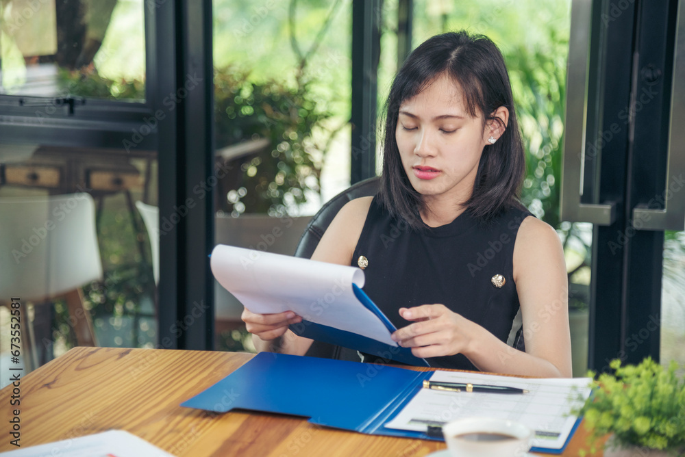 Fototapeta premium Woman working business office desk using laptop work from home. Businesswoman looking financial business chart, graph, infographic analyze sale statistics. Woman hands on entrepreneur office desk