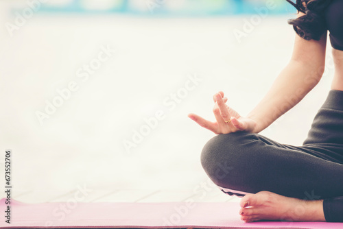 Yoga fitness lifestyle healthy woman relaxation doing a meditation. Yoga meditate outdoor with zen on sitting position. Yoga woman workout in sportswear sit on yoga mat home fitness workout exercise