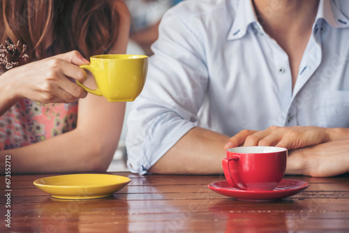 Fototapeta Naklejka Na Ścianę i Meble -  Young couple talking in cafe coffee shop happy date couple communication positive relationship while relaxing in cafe drinking coffee and talkative. Valentine's day concept.