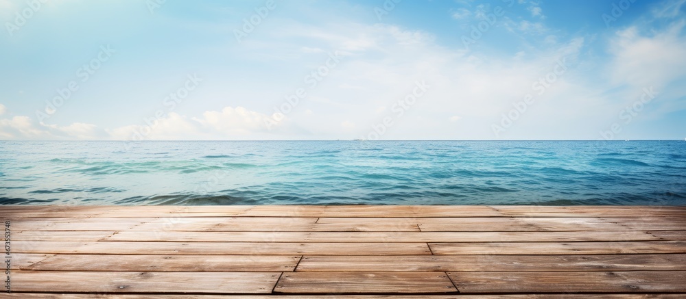 Summer scenery with a sea backdrop includes a wooden pier