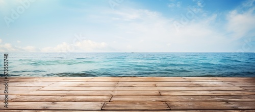 Fototapeta Naklejka Na Ścianę i Meble -  Summer scenery with a sea backdrop includes a wooden pier