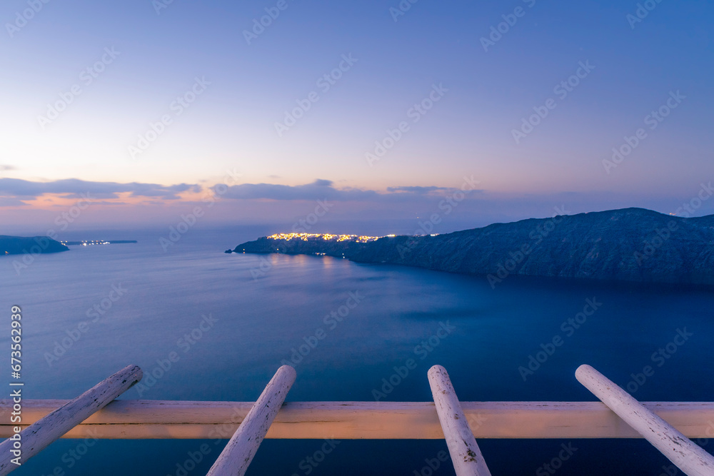 Sunset view of Santorini cliffs and Oia city