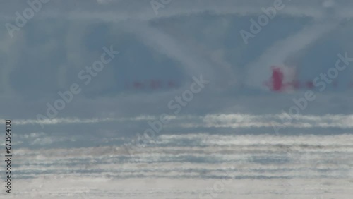 Close-up of Airplane Wheels Touching Down on Runway photo