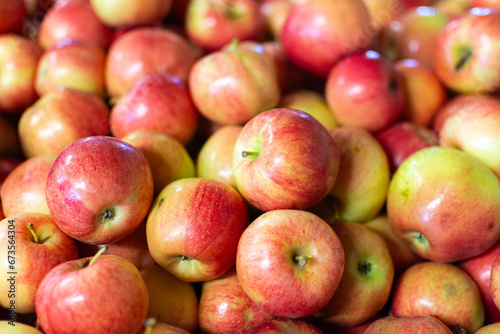 Detail of a bushel of ripe red apples on display in the market. photo