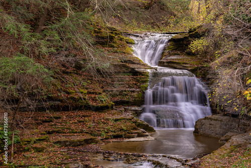 Afternoon fall  autumn photo of a waterfall in Robert H. Treman State Park near Ithaca NY  Tompkins County New York. 