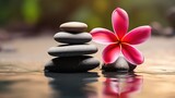 zen stones with deep red plumeria flower on blurred background.copy space
