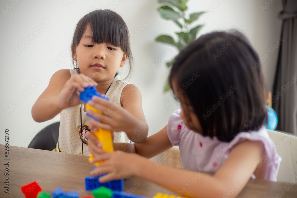 Adorable little girl playing toy blocks in a bright room Adorable little girl playing toy blocks in a bright room