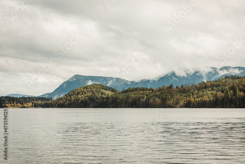 Lake and tree covered mountains in autumn © Martin
