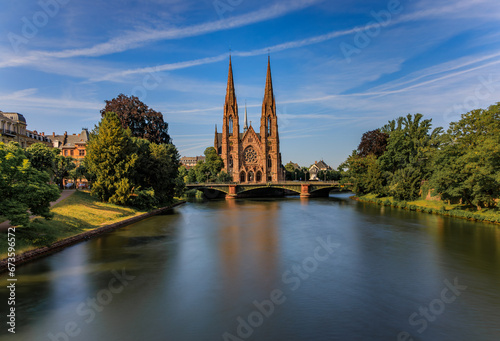 View onto the facade and twin spires of Staint Paul Protestant Church, a major Gothic Revival landmark above the Ill River, Strasbourg, Alsace, France