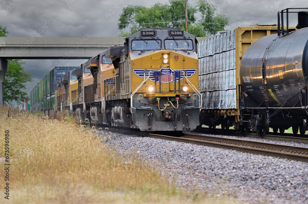 Union Pacific Railroad freight trains pass in northeastern Illinois as a westbound intermodal