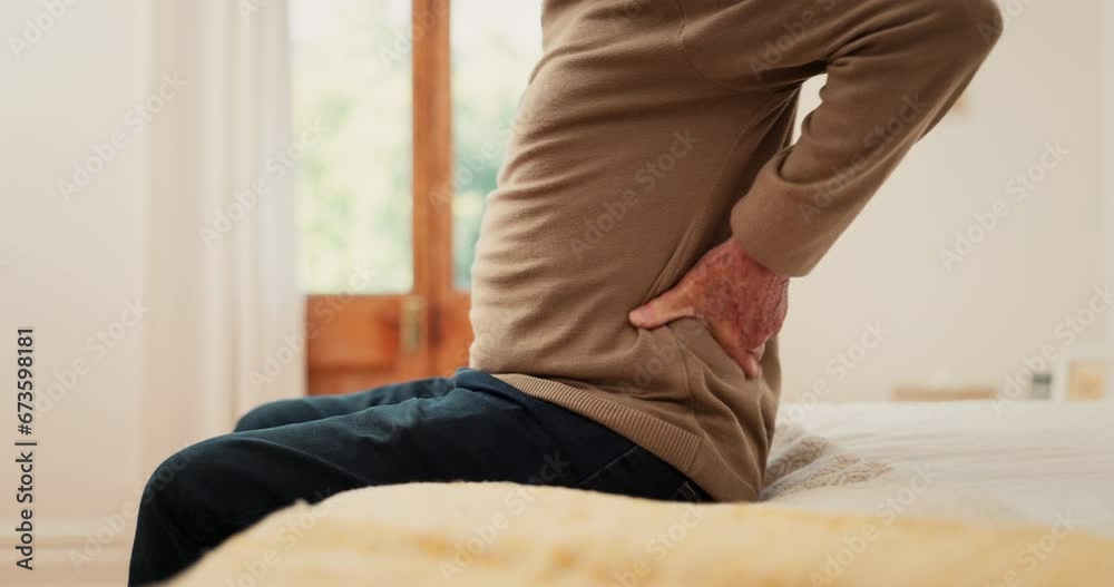 Hands, man and pain in home from back, muscle injury or risk of fatigue for scoliosis in bedroom. Closeup, bad posture and stretching spine for fibromyalgia, osteoporosis and healthcare for arthritis Hands, man and pain in home from back, muscle injury or risk of fatigue for scoliosis in bedroom. Closeup, bad posture and stretching spine for fibromyalgia, osteoporosis and healthcare for arthritis