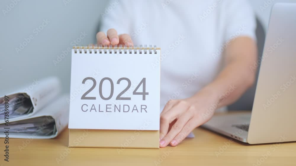 2024 Year Calendar on table with business woman using laptop computer ...