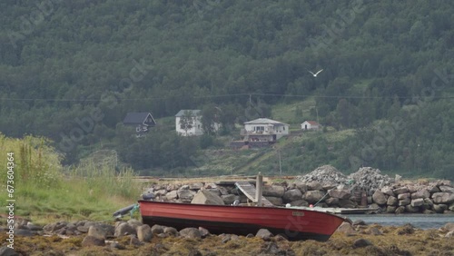 Small Boat On The Shore In The Village Of Medby In Senja, Norway. wide photo