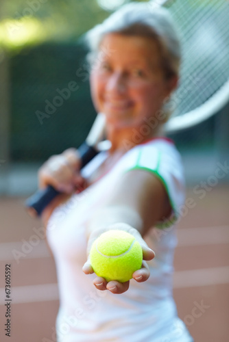 Sports, tennis ball and woman athlete on a court for exercise, workout or training for competition. Fitness, equipment and confident young female person practicing or playing a game or match. © Nicola Katie/peopleimages.com