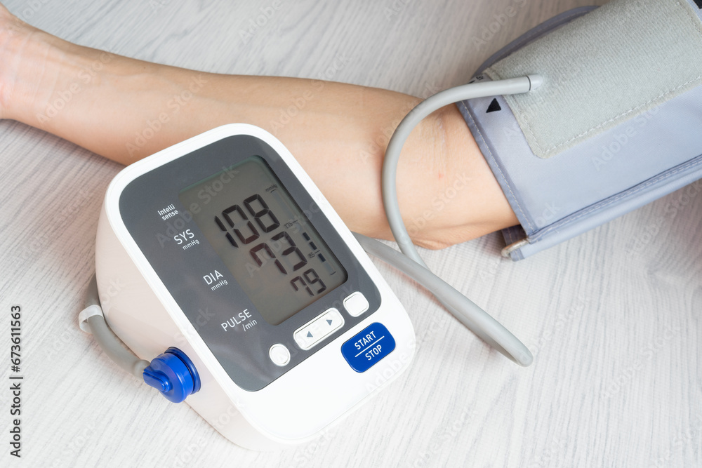 Man check blood pressure monitor and heart rate monitor with digital pressure gauge. Health care and Medical concept Man check blood pressure monitor and heart rate monitor with digital pressure gauge. Health care and Medical concept