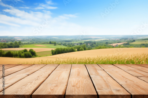 Wooden table on bright summer farmland background