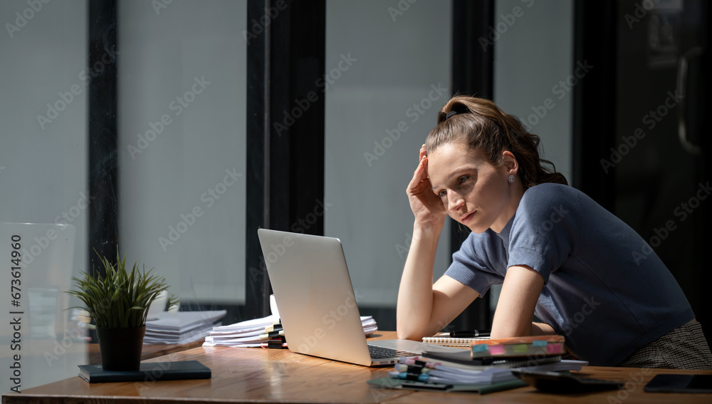 Young women are stressed while working on laptop, Tired businesswoman with headache at office, feeling sick at work, copy space Young women are stressed while working on laptop, Tired businesswoman with headache at office, feeling sick at work, copy space