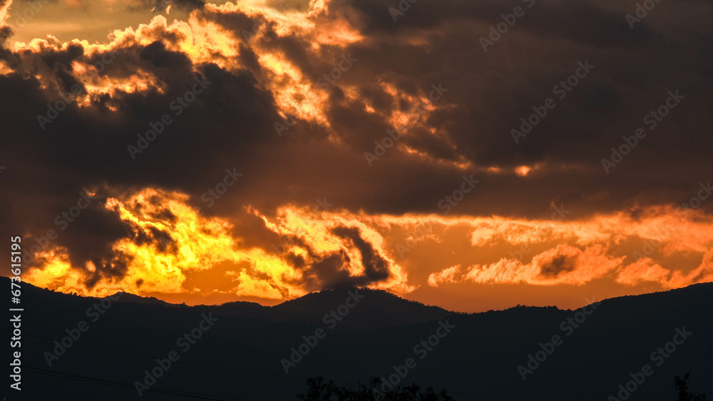 Beautiful dramatic sky with clouds at sunset or sunrise. Sunset sky at dusk in the evening with natural sky background with golden orange clouds. Beautiful dramatic sky with clouds at sunset or sunrise. Sunset sky at dusk in the evening with natural sky background with golden orange clouds.