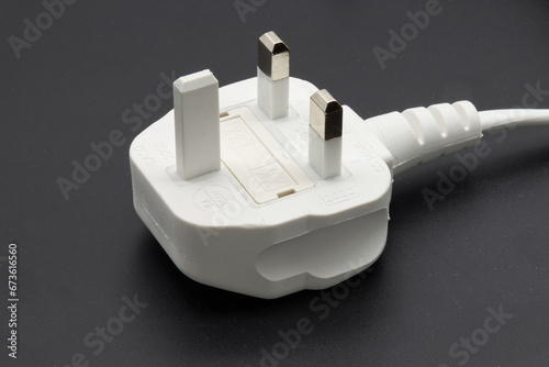 UK type power cable isolated on black background