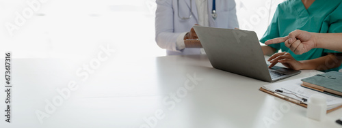 A group of doctors meets together to solve the problem of the epidemic, There was a meeting about major surgery in the hospital, The doctor takes the patient's documents and discusses them with team.