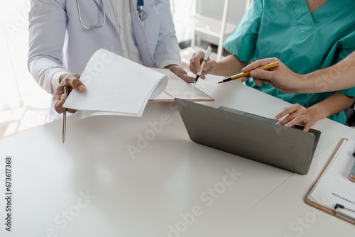 Cuadro en lienzo A group of doctors meets together to solve the problem of the epidemic, There was a meeting about major surgery in the hospital, The doctor takes the patient's documents and discusses them with team