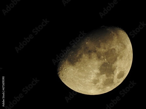 Half moon on a black background. Copy space. Close up