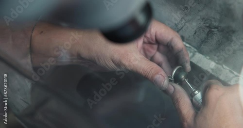 jeweler polishes a ring during the making process in a workshop photo