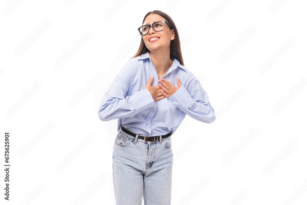 young pretty european business woman with long black hair dressed in a blue blouse and glasses on a white background with copy space young pretty european business woman with long black hair dressed in a blue blouse and glasses on a white background with copy space