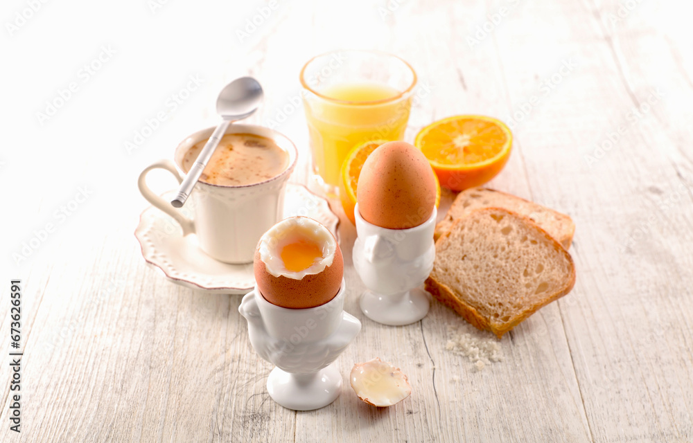 Soft boiled egg with orange juice, bread and coffee cup Soft boiled egg with orange juice, bread and coffee cup