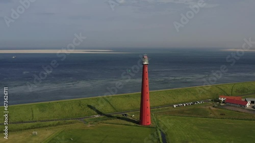 Drone shot, drone flight from the lighthouse Huisduinen, called the long Jaap with the North Sea in the background, Nieuw Den Helder, Huisduinen, province North Holland, Netherlands photo