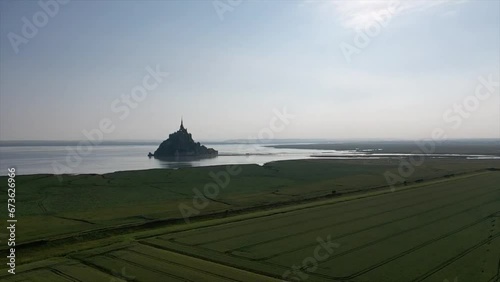 Drone shot, drone flight to the historic monastery Le Mont Saint Michel with a view of the salt marshes and the approach dam in the morning light, Pontorson, Departement Manche, Normandy, France photo