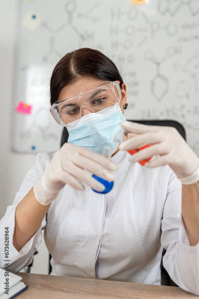 Young woman laboratory technician mixed flask with liquid, research in clinical laboratory Young woman laboratory technician mixed flask with liquid, research in clinical laboratory