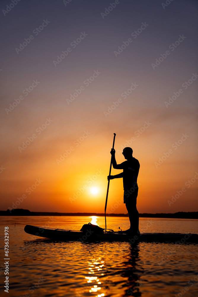 A man standing on top of a boat in the water. A Man Standing on Top of a Boat, Enjoying the Serene Waters