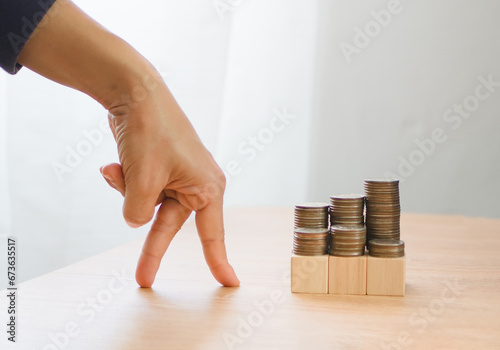 business and finance growth concept. Fingers walking up on coins stack and row of coin. collecting money, financial planning, save money for the future.