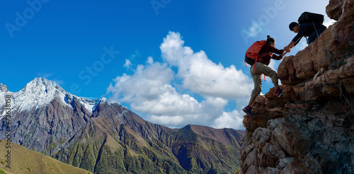 Asian hiking help each other on mountains