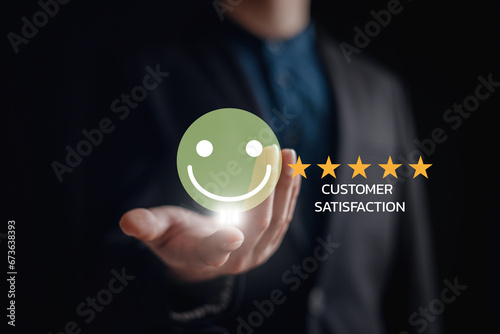 customer service evaluation and feedback rating. costumer review concept  man using phone chooses happy smiling face