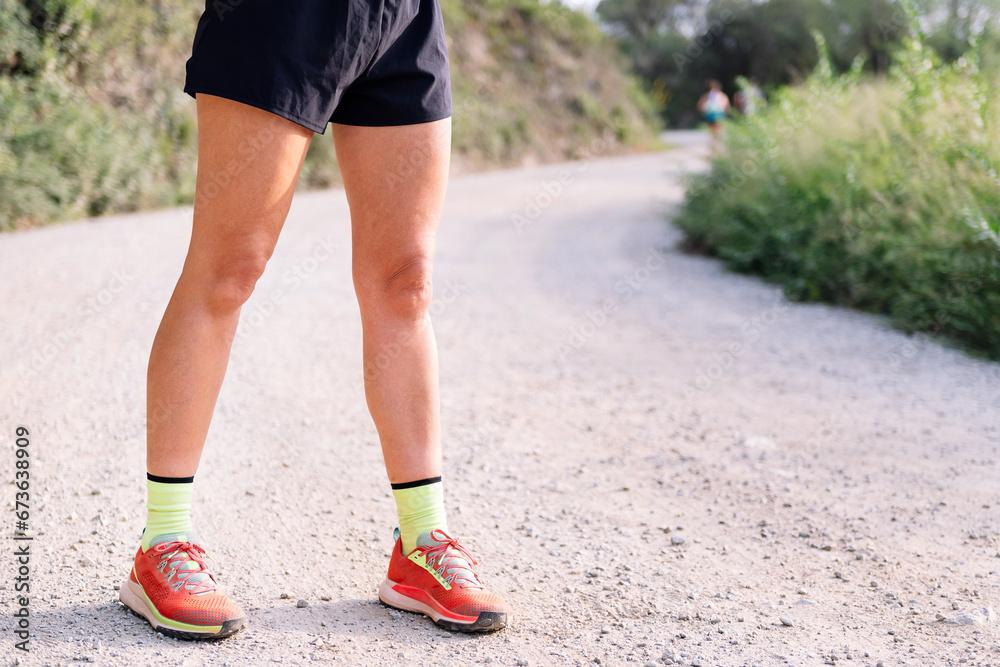 fitness legs of an unrecognizable sportswoman in the countryside, concept of sport in nature and active lifestyle, copy space for text fitness legs of an unrecognizable sportswoman in the countryside, concept of sport in nature and active lifestyle, copy space for text