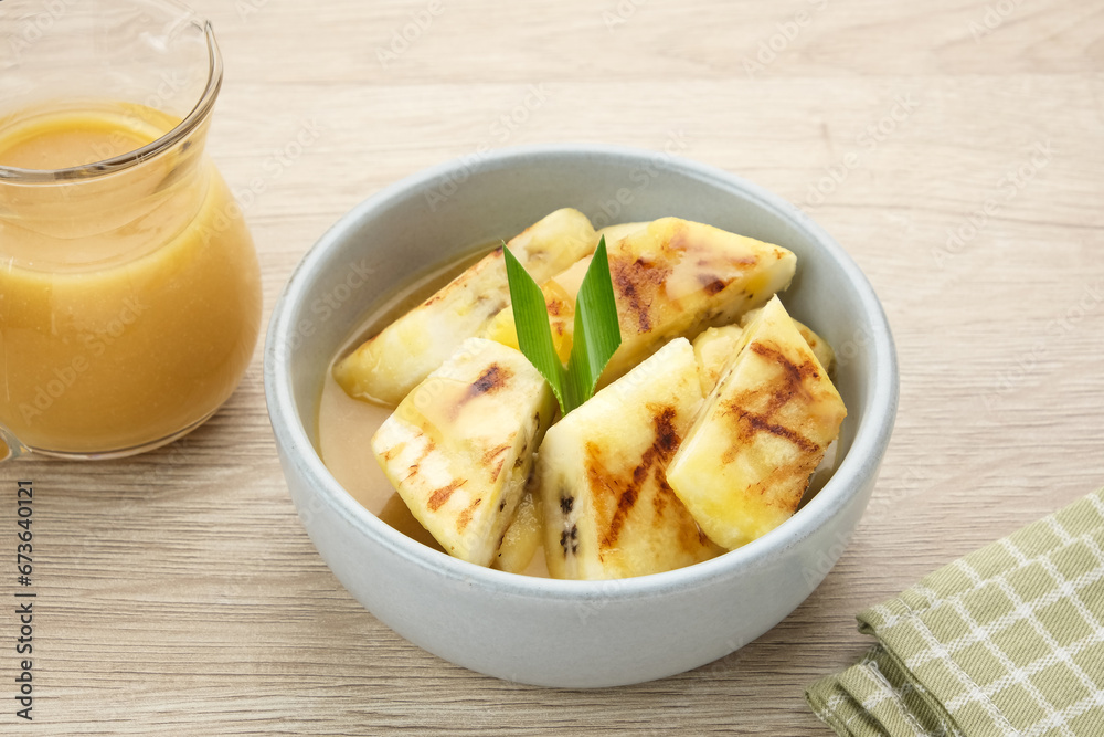 Pisang Gapit or Pisang Epe, grilled banana with palm sugar sauce. Indonesian traditional food.
Pisang Gapit or Pisang Epe, grilled banana with palm sugar sauce. Indonesian traditional food.