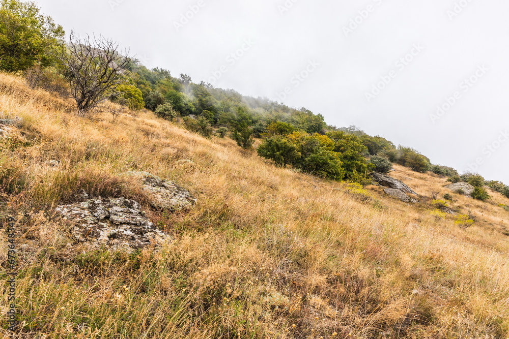 Mysterious mountain landscape of the Valley of Ghosts on the western slope of Mount Demerdzhi in Crimea. Popular tourism and trekking destination Mysterious mountain landscape of the Valley of Ghosts on the western slope of Mount Demerdzhi in Crimea. Popular tourism and trekking destination