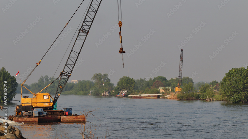 Fototapeta premium Under construction of concrete dam with heavy equipment