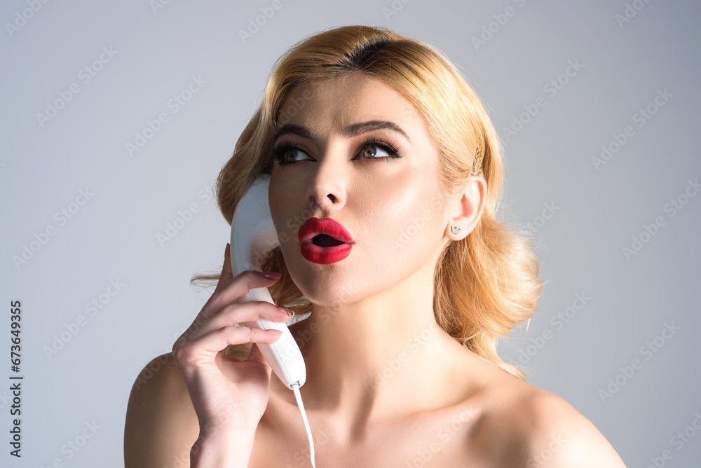 Sexy woman talking on retro telephone. Retro landline telephone