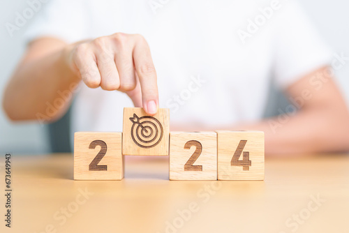 2023 year change to 2024 year block with dartboard icon. Goal, Target, Resolution, strategy, plan, Action, mission, motivation, and New Year start concepts