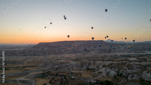 Hot air balloons. Hot air balloons flying over fairy chimneys in Cappadocia. Aerial view. Turkey tourist attractions © enezselvi
