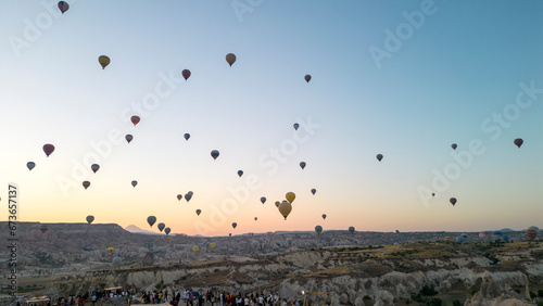 Hot air balloons. Hot air balloons flying over Fairy chimneys in Cappadocia at sunrise. Aerial view. Turkey tourist attractions