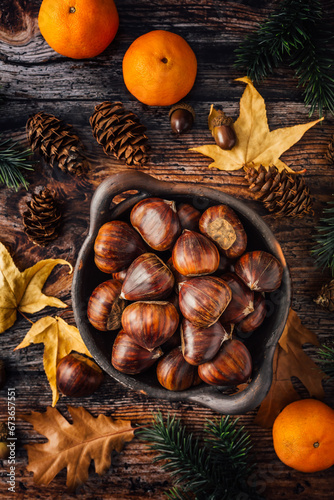 Organic sweet chestnuts in a bowl on kitchen table