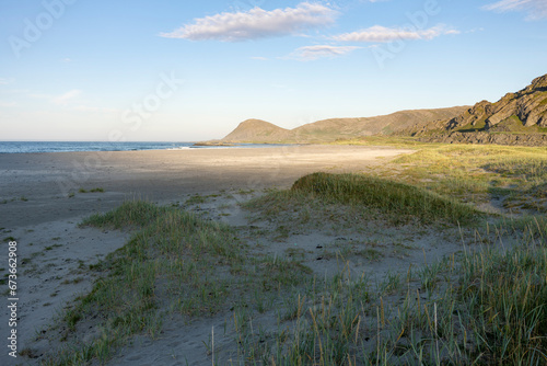 Beautiful and calm summer evening on a beach by the Barents Sea in Northern Norway photo