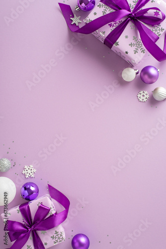 Extend felicitations with vertical top view of violet gift boxes, white and lilac baubles, radiant glitter, and snowy accents against a purple setting. An ideal space for text or promotions